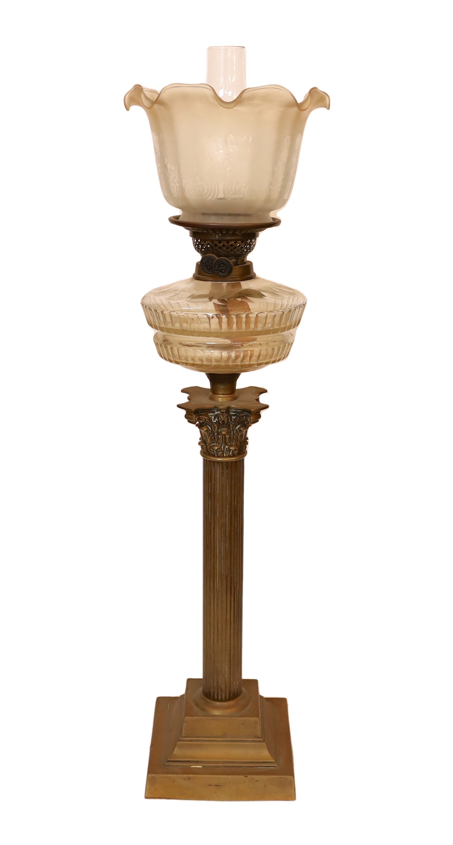 An Edwardian brass Corinthian column oil lamp with cut glass reservoir, Castle Brand mechanism and etched glass shade, height overall 86cm.